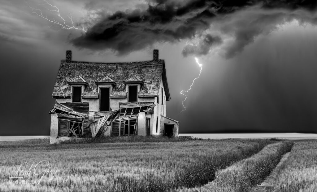 An abandoned house with lightning in the sky